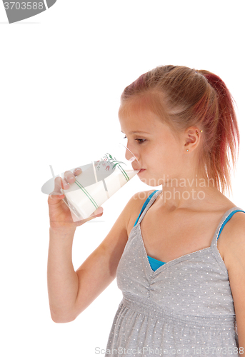 Image of Young girl drinking a glass of milk.