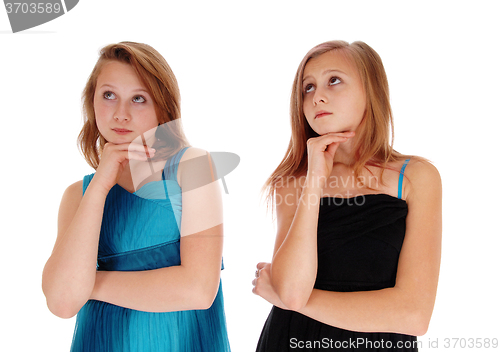 Image of Two pretty girls thinking hard.