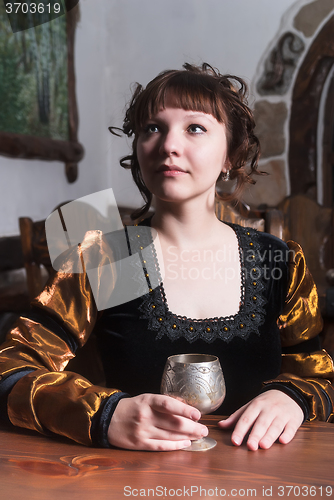 Image of Pretty woman an armchair and with wine glass