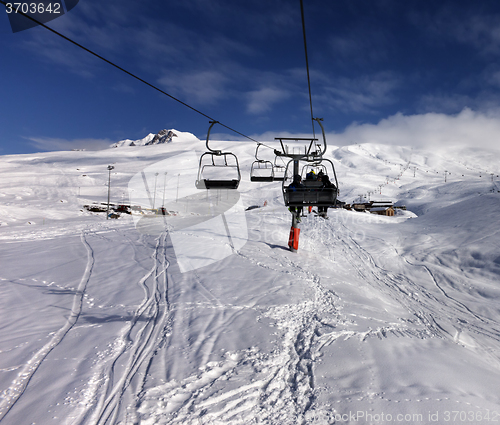 Image of Chair-lift and off-piste slope in nice sun day
