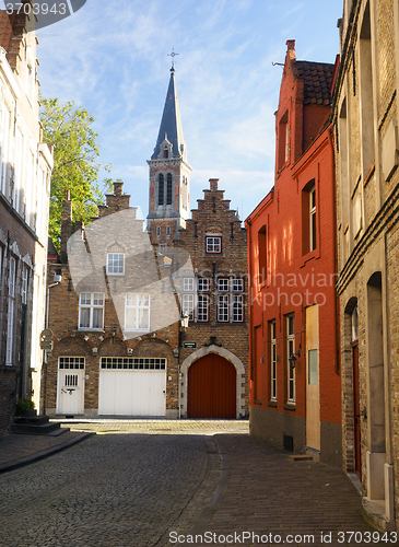 Image of medieval buildings on cobblestone street  garage and cathedral i