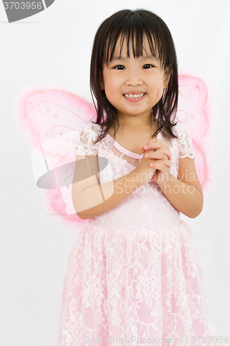 Image of Chinese little girl wearing butterfly custome with praying gestu