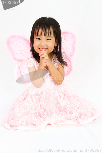 Image of Chinese little girl wearing butterfly custome with praying gestu
