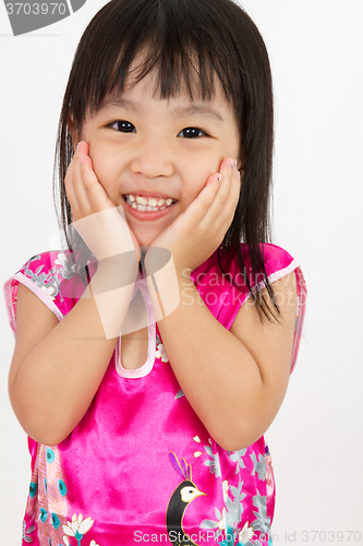 Image of Chinese Little Girl wearing Cheongsam with greeting gesture