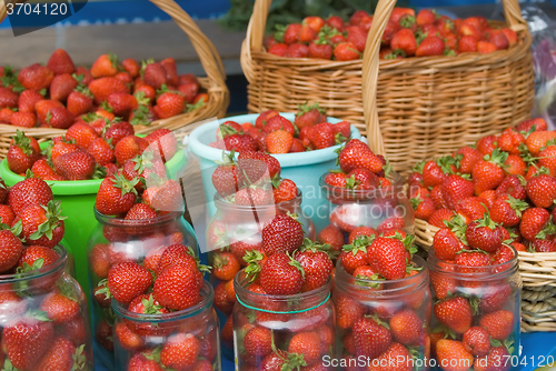 Image of Strawberry collected in jar, buckets and baskets
