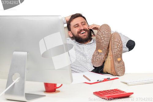 Image of Portrait of businessman talking on mobile phone in office