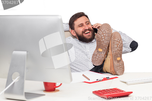 Image of Portrait of businessman talking on mobile phone in office