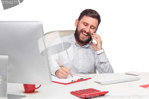 Image of Portrait of businessman talking on mobile phone in office