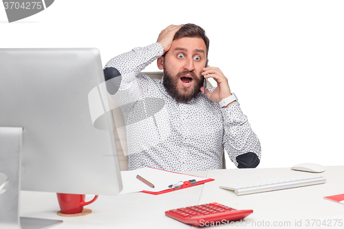 Image of Portrait of businessman talking on mobile phone in office