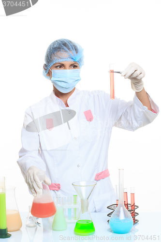 Image of very beautiful Woman chemist and chemicals in flasks, isolated on white