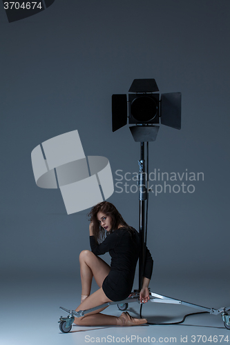 Image of The beautiful ballerina posing on dack blue background  