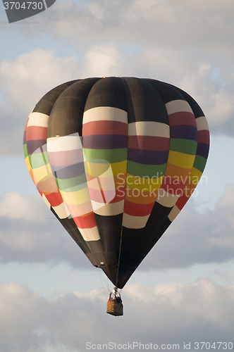 Image of Hot-Air Balloon Floating Among Clouds