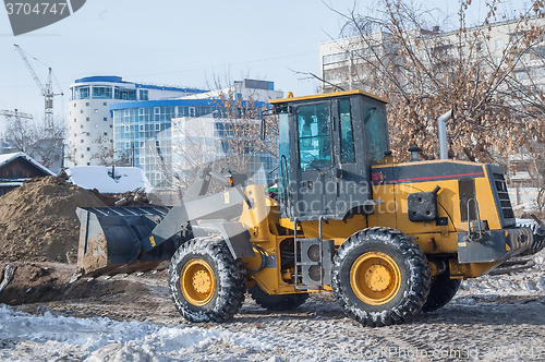 Image of Tractor removes debris from building demolition