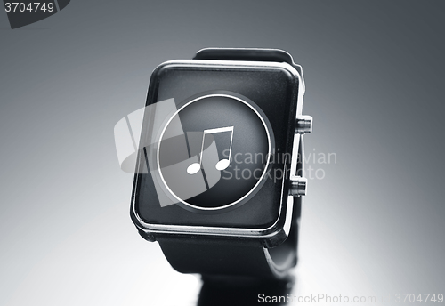 Image of close up of black smart watch with music note icon