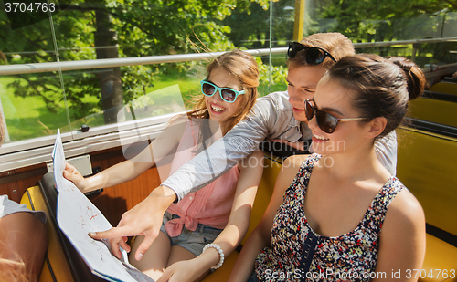 Image of group of smiling friends traveling by tour bus