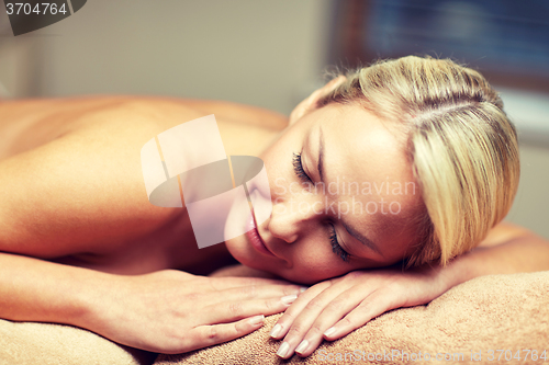 Image of close up of woman lying on massage table in spa