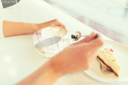 Image of close up of woman hands with cake and coffee