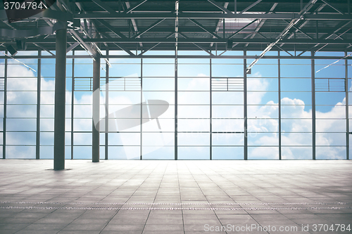 Image of airport terminal room over blue sky and clouds