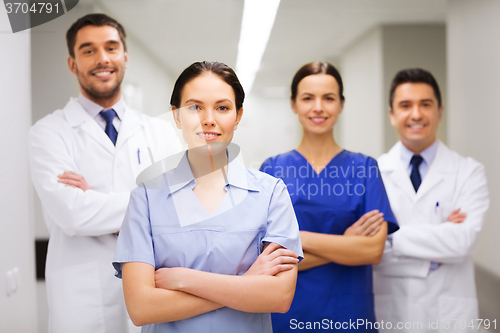 Image of happy group of medics or doctors at hospital