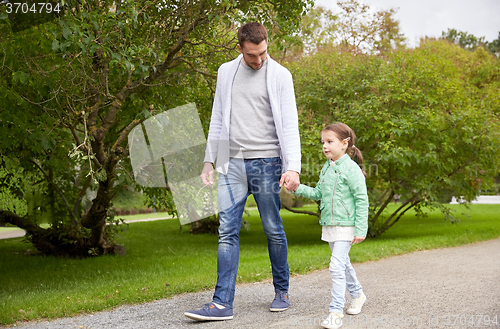 Image of happy family walking in summer park