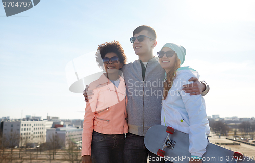 Image of happy teenage friends in shades talking on street