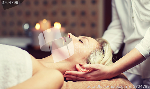 Image of close up of woman having face massage in spa