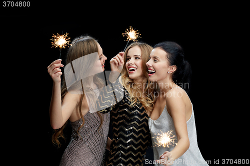 Image of happy young women dancing at night club disco