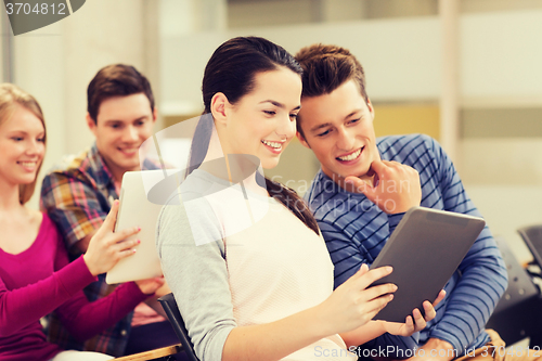 Image of group of smiling students with tablet pc