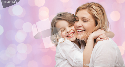 Image of happy mother and daughter hugging