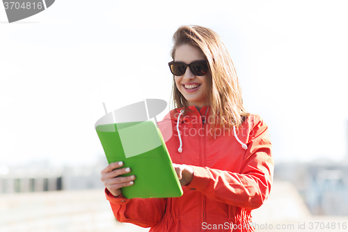 Image of happy young woman or teenage girl with tablet pc