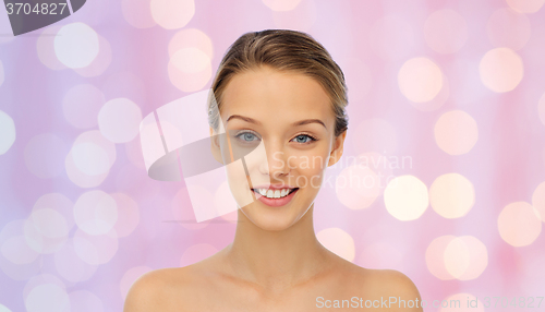Image of smiling young woman face and shoulders
