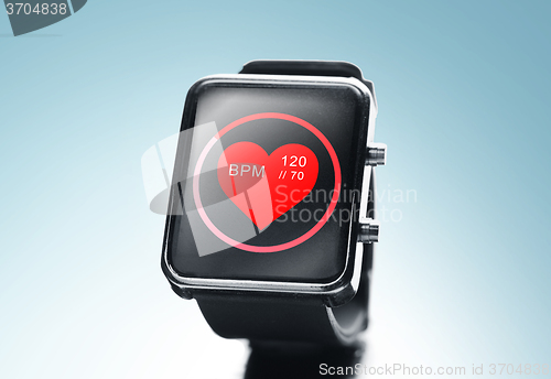 Image of close up of black smart watch with heart beat icon