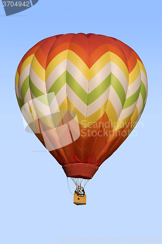 Image of Hot-Air Balloon Floating Against Blue Sky