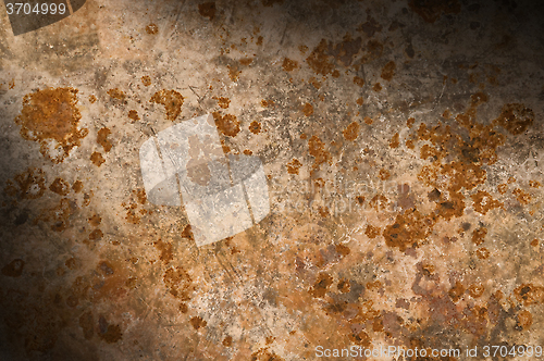 Image of Metal background with rusty corrosion lit diagonally