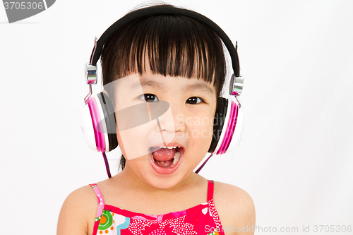 Image of Chinese little girl on headphones