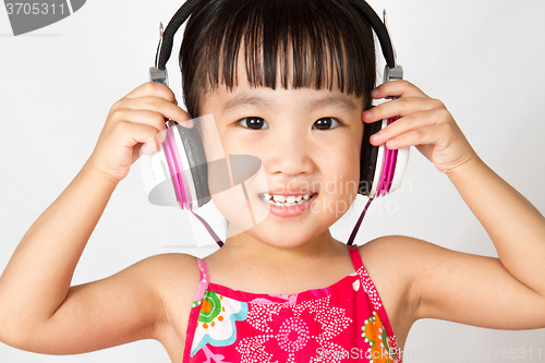 Image of Chinese little girl on headphones