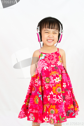 Image of Chinese little girl on headphones