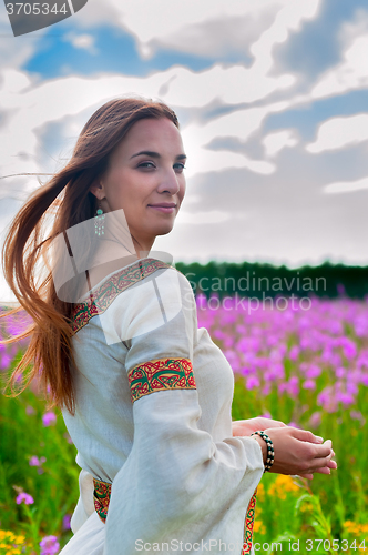 Image of Beautiful woman relaxing on meadow with flowers