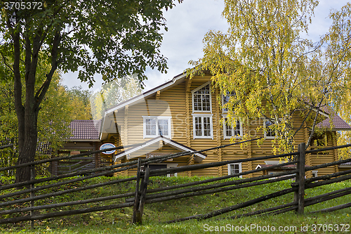 Image of Big yellow rural wooden house in autumn