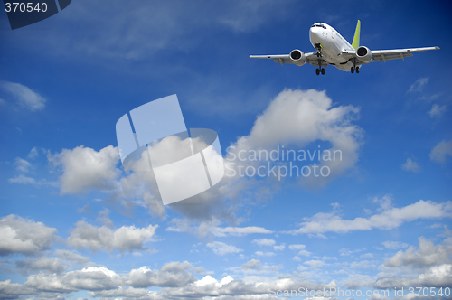 Image of Air travel - Plane flying in blue sky with clouds