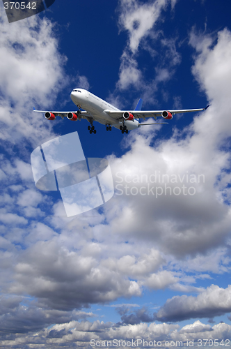 Image of Air travel - Plane is flying in blue sky with clouds