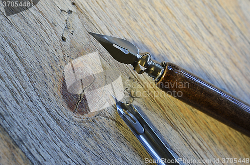 Image of fountain pen on wooden background 