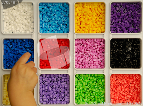 Image of Child playing with toy pearls