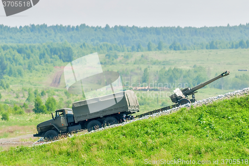 Image of army truck transports a gun