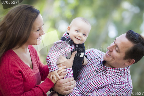 Image of Little Baby Boy Having Fun With Mother and Father Outdoors