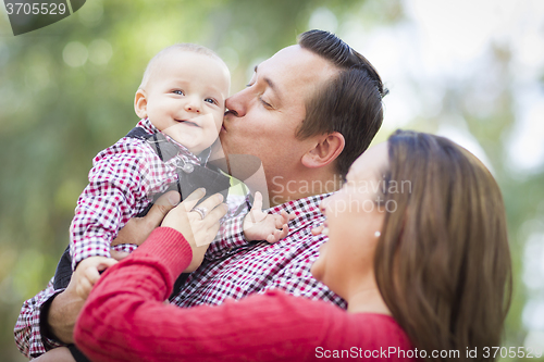 Image of Little Baby Boy Having Fun With Mother and Father Outdoors