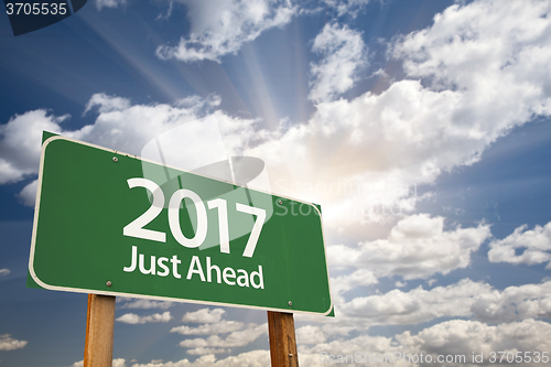 Image of 2017 Just Ahead Green Road Sign Against Clouds