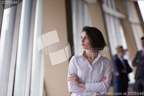 Image of business people group, woman in front  as team leader