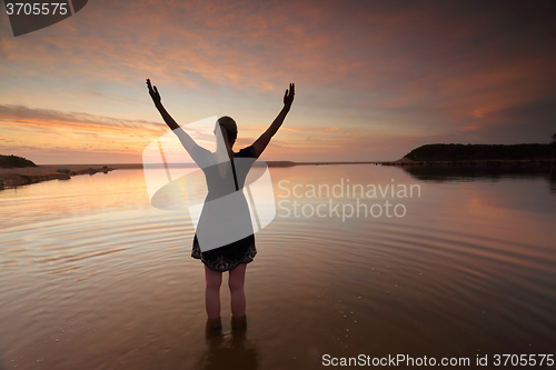 Image of Woman outstretched arms praising perfect day success