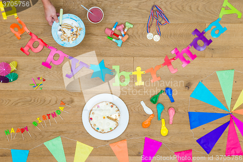 Image of Cake And Birthday Decorations On Wooden Table